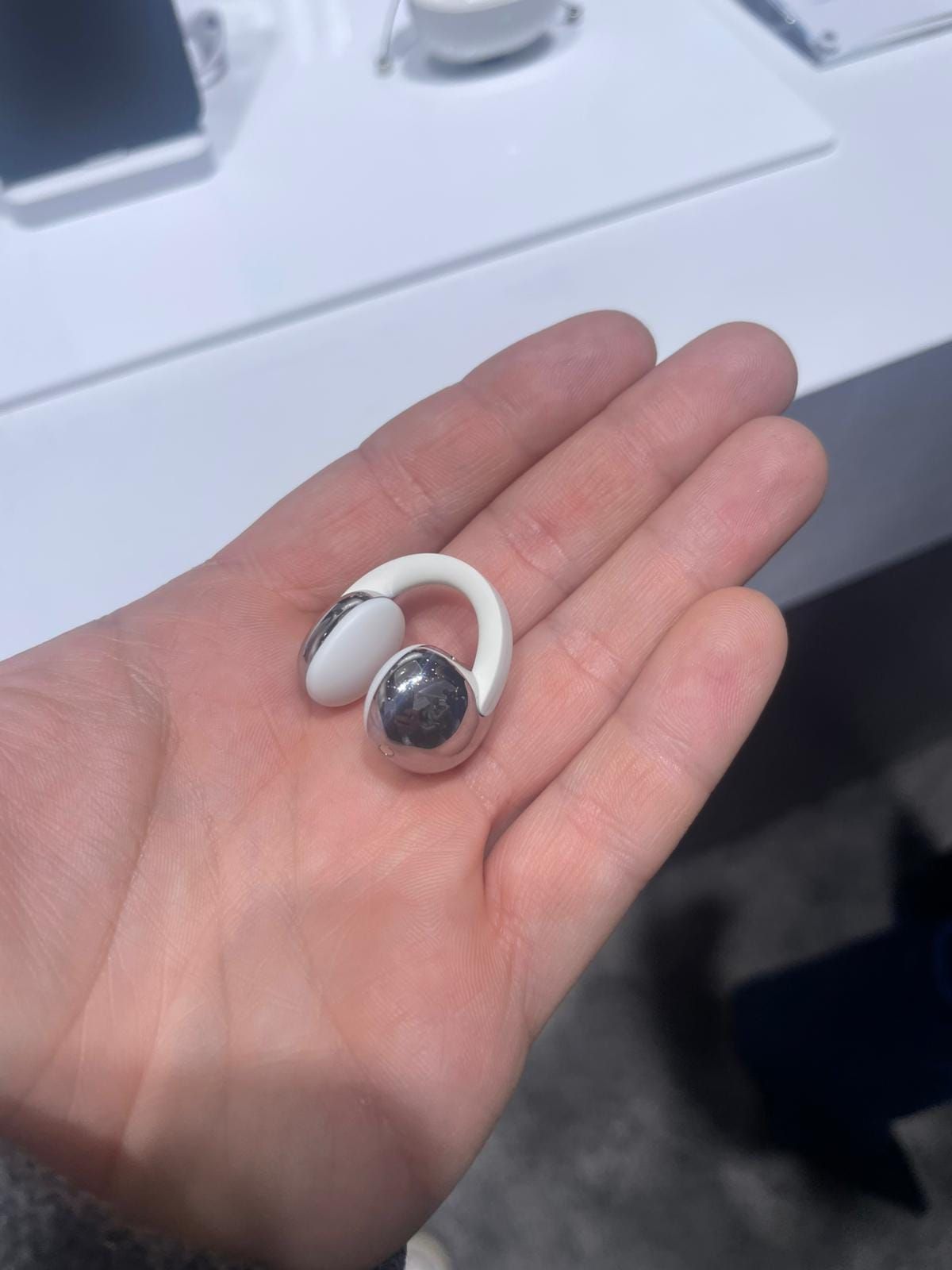 Fotografía de un auricular TCL CrystalClip de tipo clip durante su presentación en el MWC 2026 de Barcelona